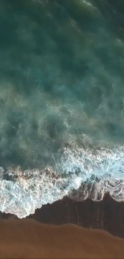 Aerial view of ocean waves meeting a sandy beach.