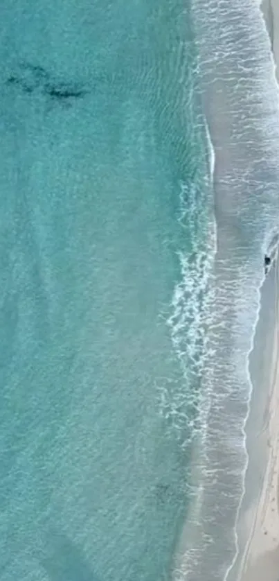 Aerial view of beach with turquoise waves and sandy shore, perfect for phone wallpaper.