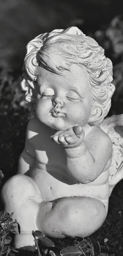 Grayscale angel statue in garden setting.