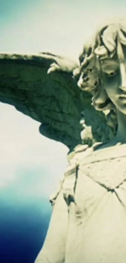 Serene angel statue on a background of clear blue sky, creating a peaceful ambiance.