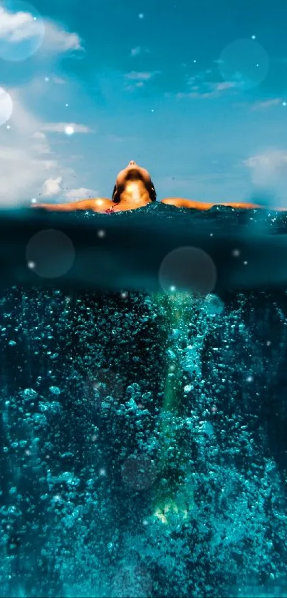 Person submerged in blue water with bright sky above.