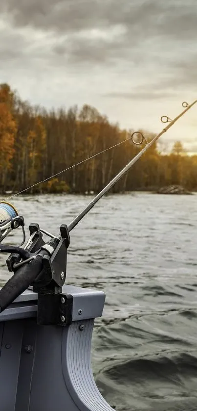 Fishing rod on lake at autumn sunset, serene nature scene.