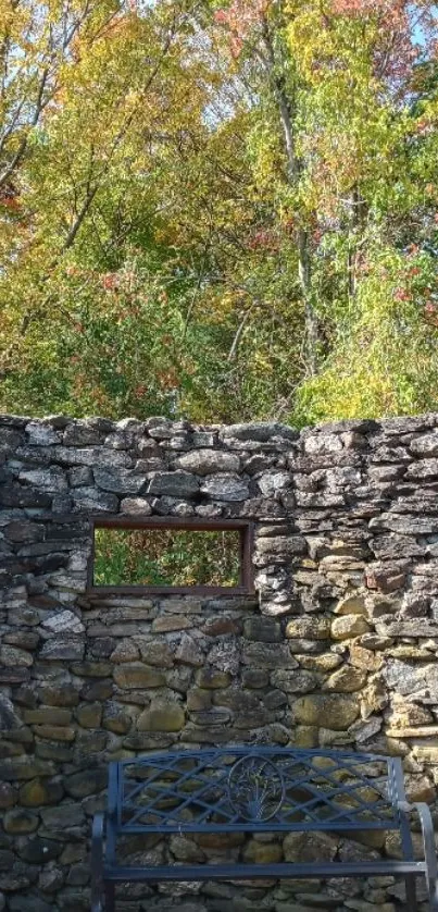 Autumn hillside with stone wall and bench scene.