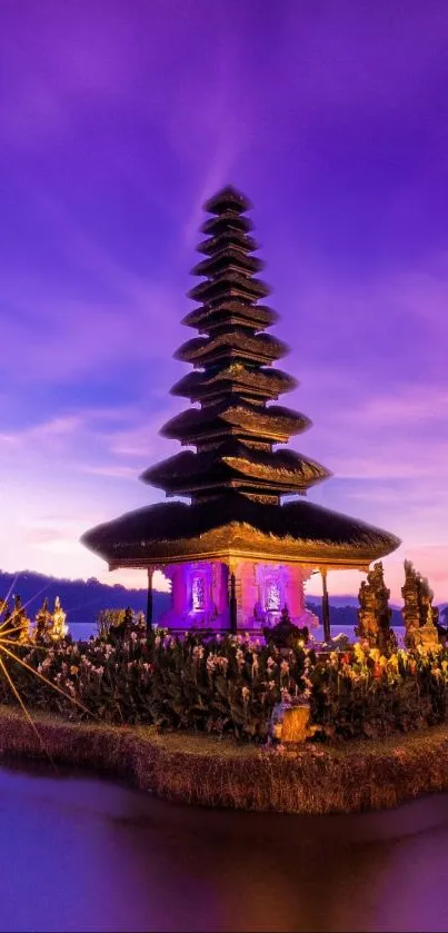 Balinese temple silhouetted against a vibrant purple sunset.