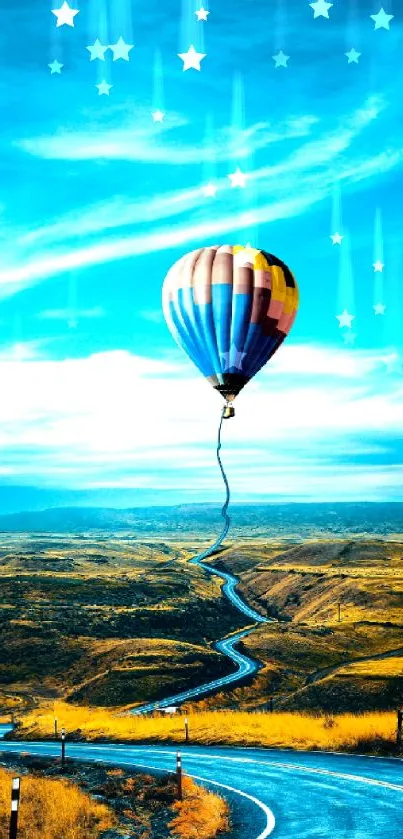 Hot air balloon over winding road in golden landscape under a blue sky wallpaper.