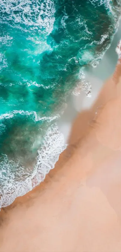 Aerial view of turquoise ocean waves on a sandy beach.