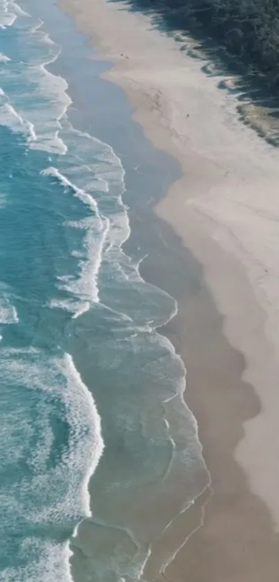 Aerial view of a serene beach with turquoise waves and sandy shores.