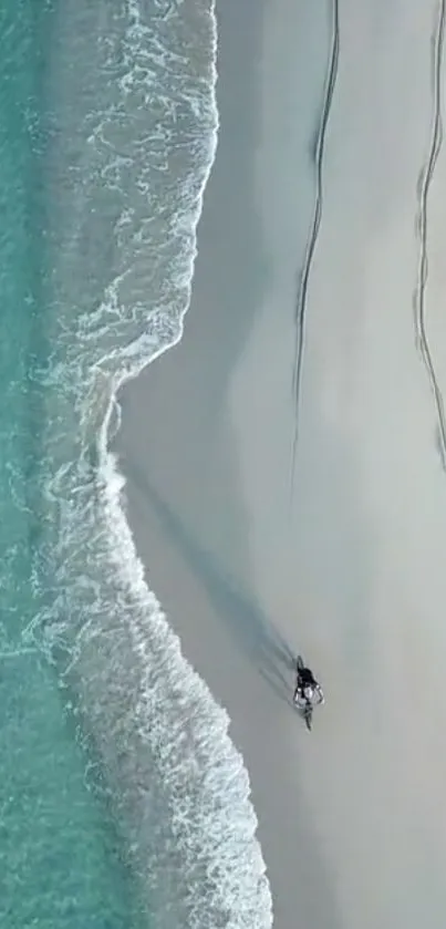 Aerial view of a serene beach with turquoise waters and gentle waves.