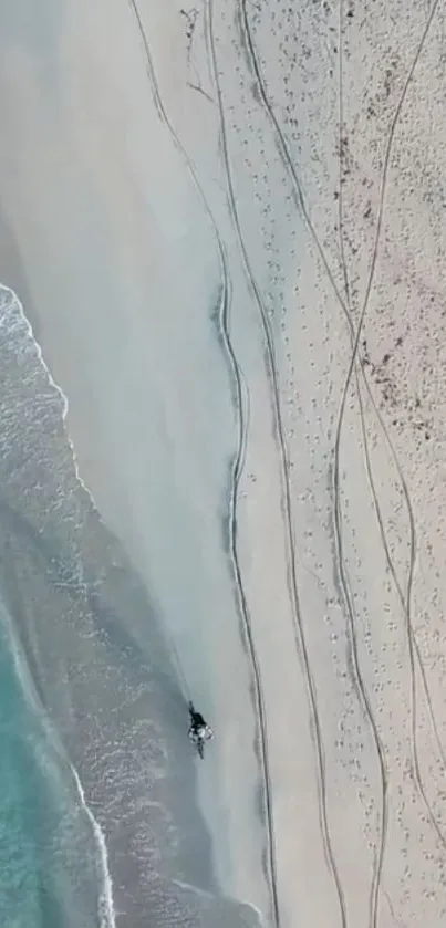 Aerial view of a serene beach with turquoise waters and sandy shores.