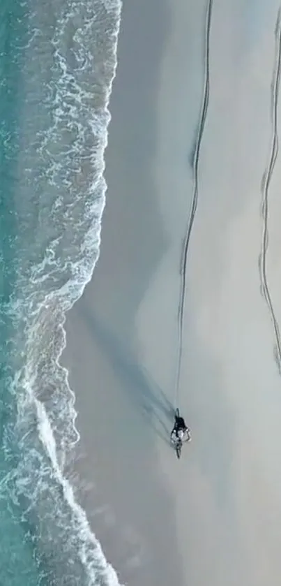 Aerial view of serene beach with turquoise waters and smooth sand.