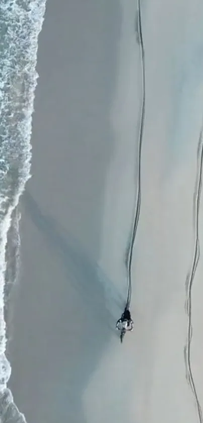 Aerial view of beach with turquoise waves and sandy shore.