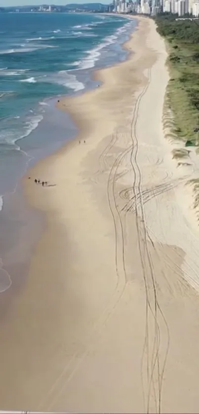 Aerial view of a serene beach with waves and sand.