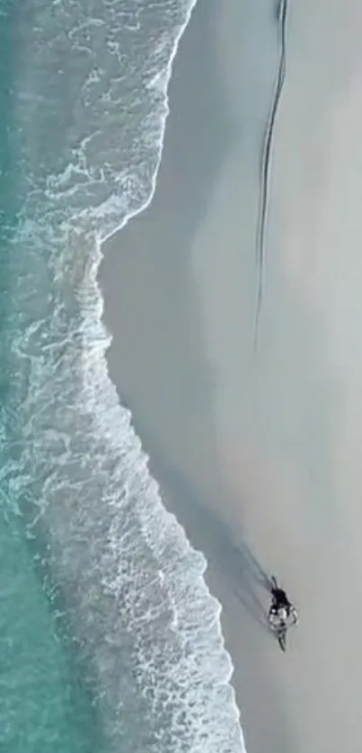 Aerial view of a serene beach with turquoise waters and white sands.