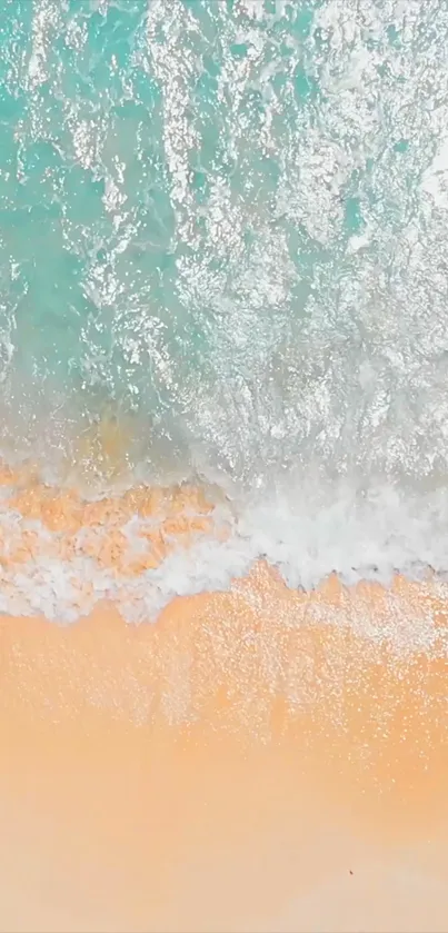 Aerial view of a tranquil beach with turquoise water and sandy shore.