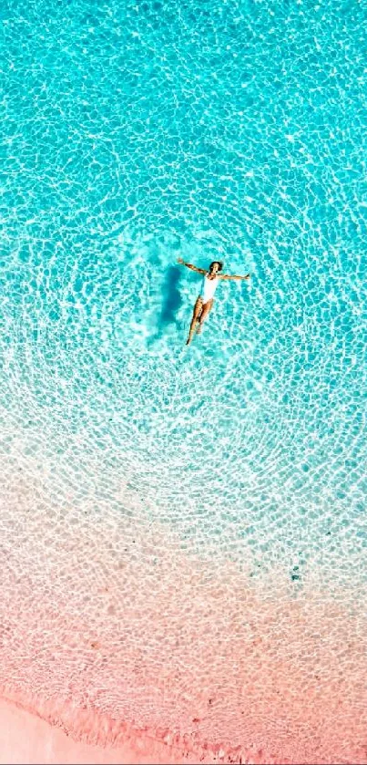 Aerial view of serene beach with turquoise water and pink sand.