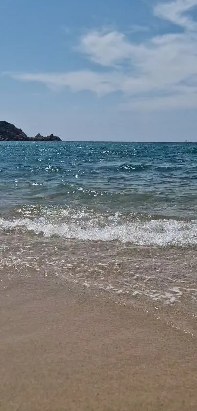 Serene beach wallpaper with waves and a clear blue sky.