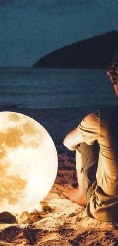 Person sitting on beach with glowing moon.