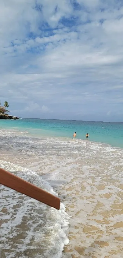 Tropical beach scene with clear waters and sandy shore.