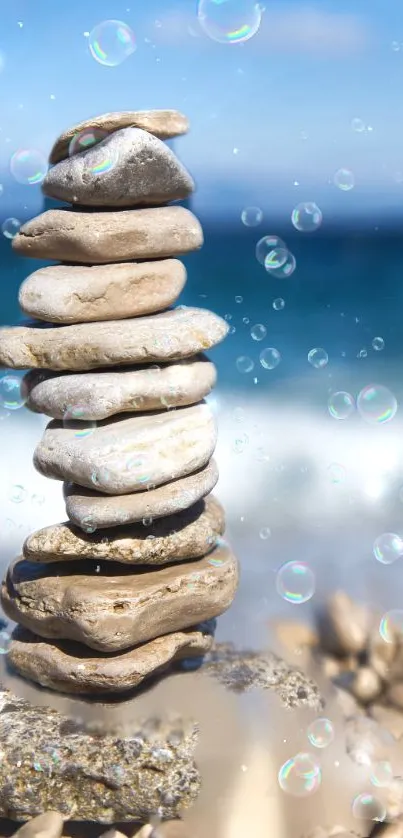 Balanced pebble stack on a serene beach with ocean waves in background.