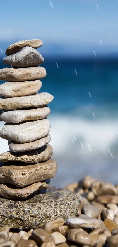 Stack of pebbles on beach with ocean waves in background.