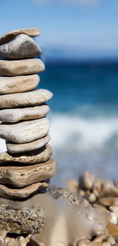 Stack of pebbles on a serene beach with ocean view.