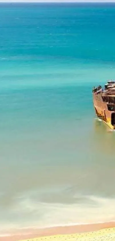 Shipwreck on turquoise beach with ocean waves.