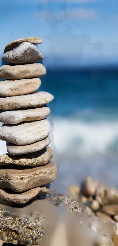 Stacked stones on a beach with blue ocean