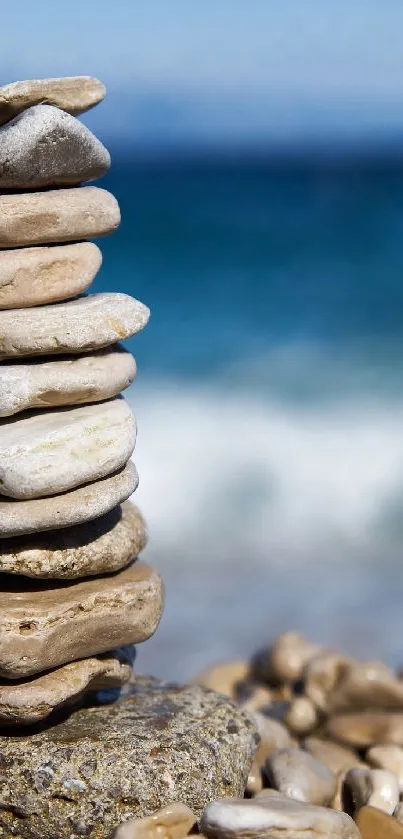 Stacked stones with ocean backdrop, serene beach wallpaper.