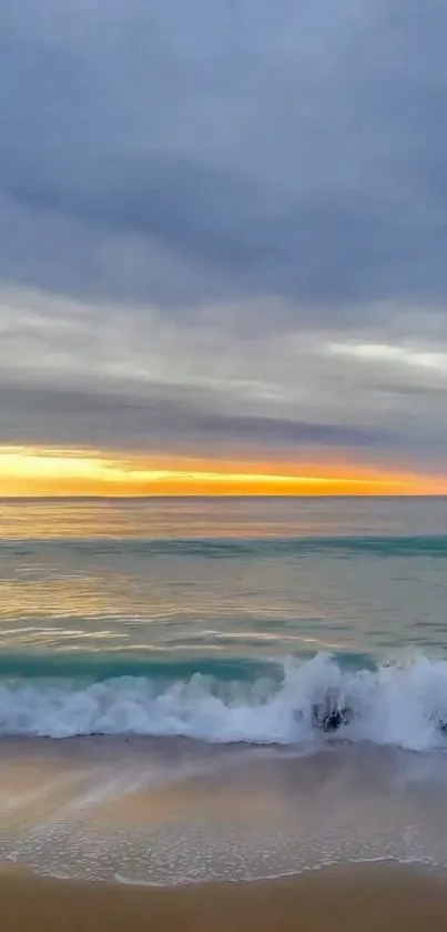 Serene beach with ocean waves at sunrise under a colorful sky.