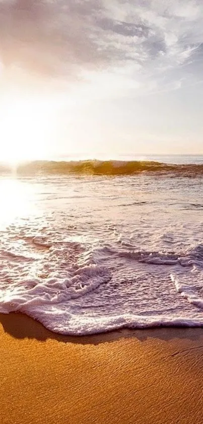 Serene sunrise over a sandy beach with ocean waves.