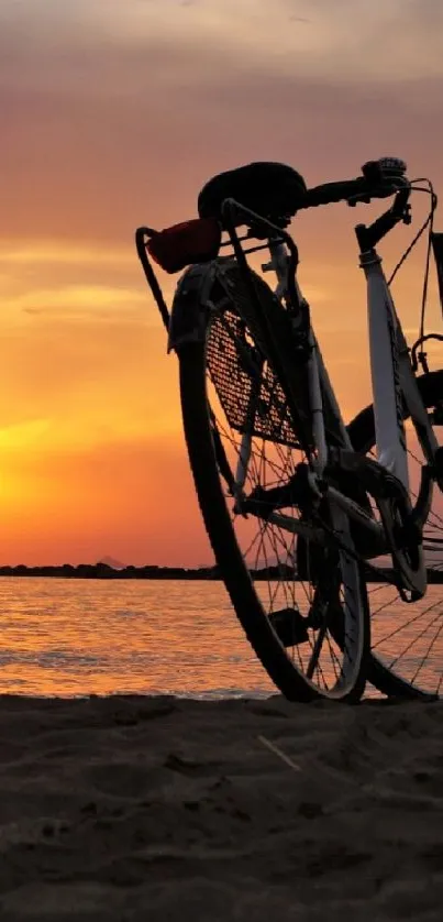 Bicycle silhouette against a vibrant sunset over a calm beach.