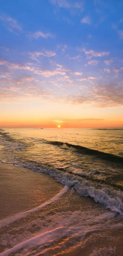 Serene sunset over a calm beach with vibrant orange and blue hues.