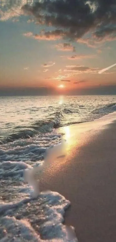 Serene sunset over a beach with gentle ocean waves.