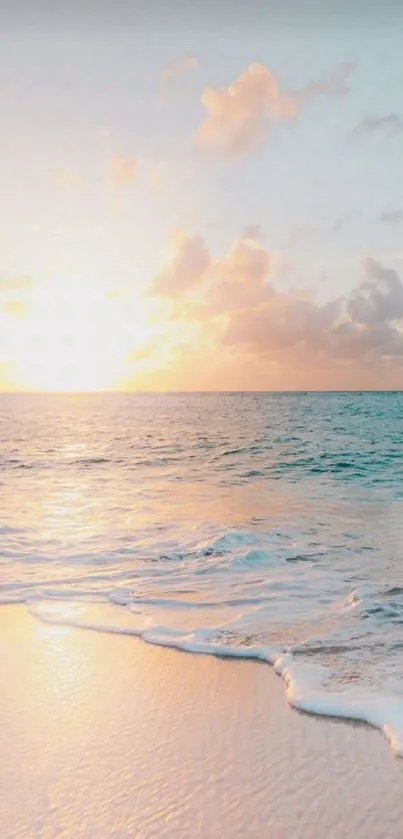 Tranquil sunrise over calm ocean waves and sandy beach.