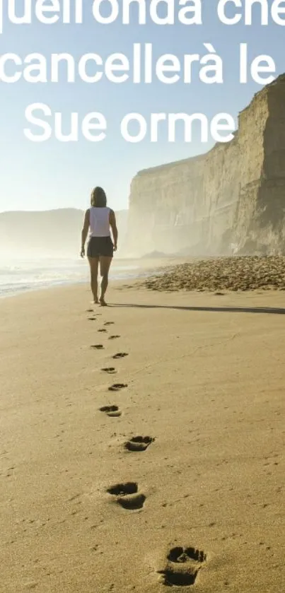 Woman walking along a sandy beach with footprints in the sand.