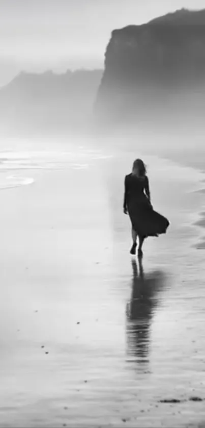 A solitary figure walks along a misty beach.