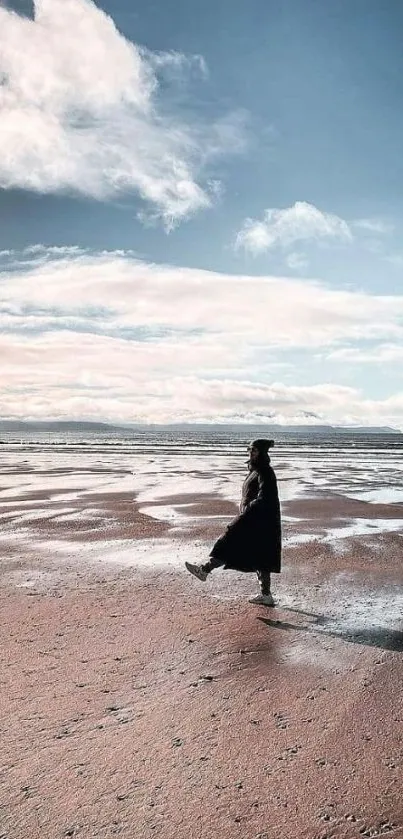 Solitary walk on serene beach under expansive sky.