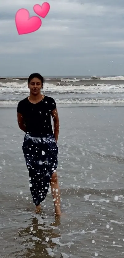 Woman walking on a serene beach with waves splashing.