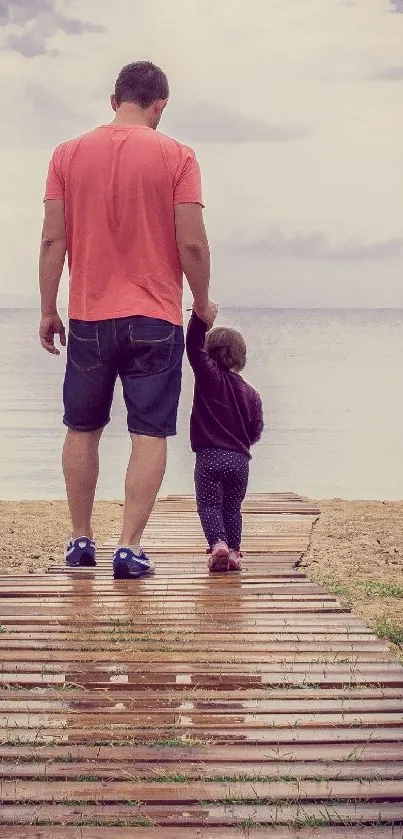 Father and child walking on a serene beach pathway.