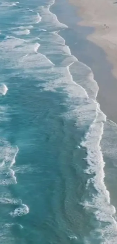 Aerial view of calming beach waves and shoreline.