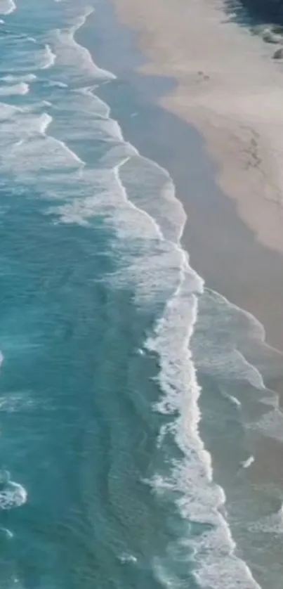 Aerial view of a serene beach with calming waves and sandy shores.