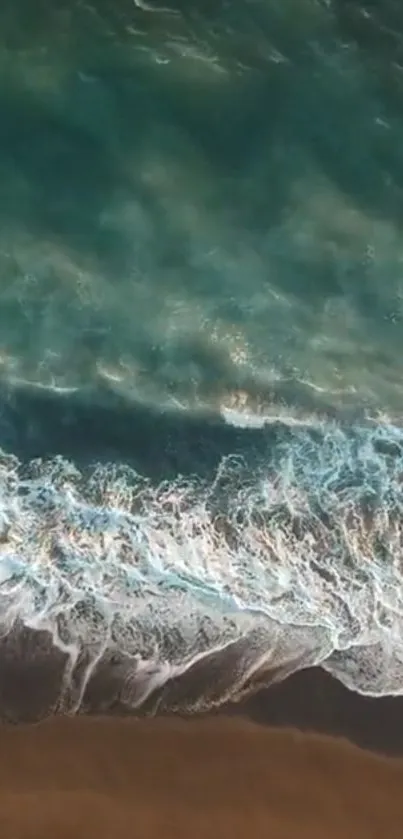 Aerial view of ocean waves and a sandy beach, captured as a calming mobile wallpaper.