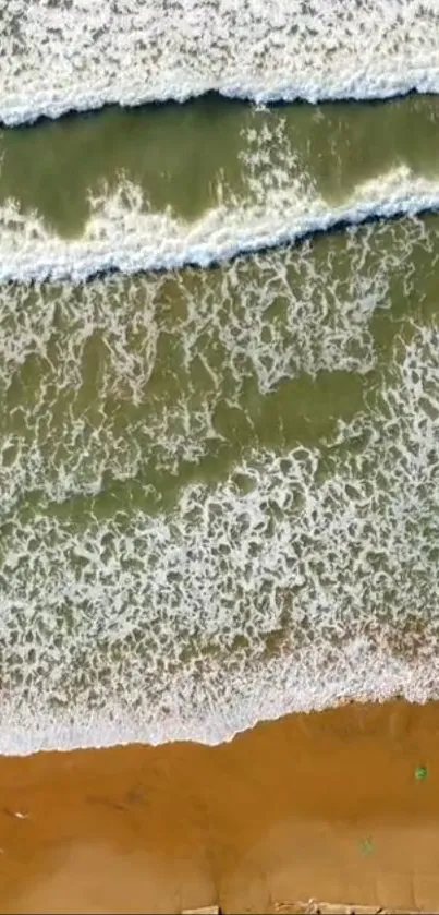 Aerial view of a serene beach with waves gently hitting the shore.