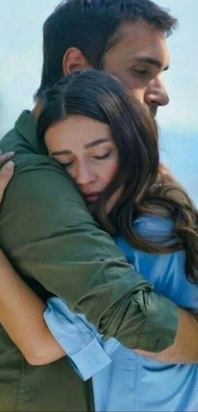 A serene embrace by the beach with a calming blue background.