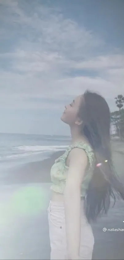 A woman peacefully enjoys the serene beachside view.