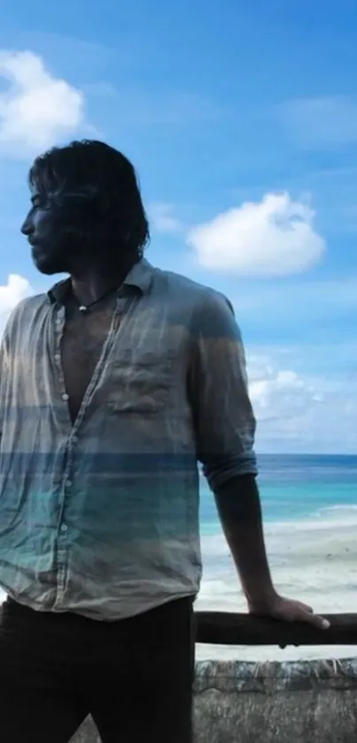 Man stands by railing overlooking serene beach and ocean under a blue sky.