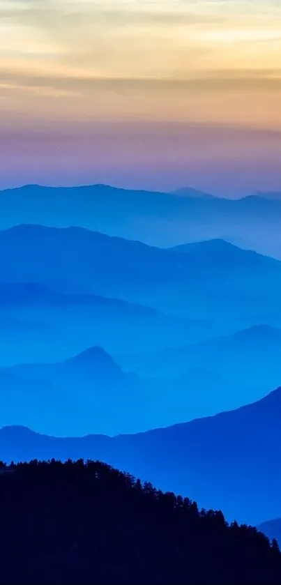 A serene blue mountain landscape at sunset, perfect for a calming wallpaper.