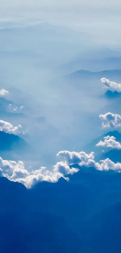 Serene blue mountain peaks with fluffy clouds.