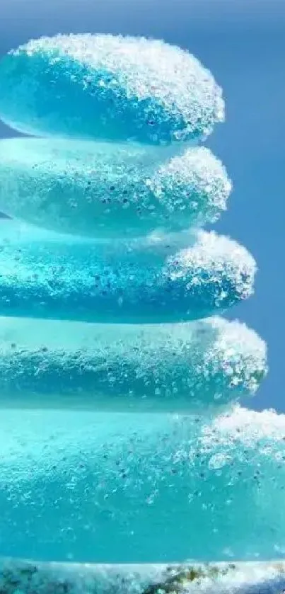 Stacked blue pebbles with a snowy texture on a light blue background.