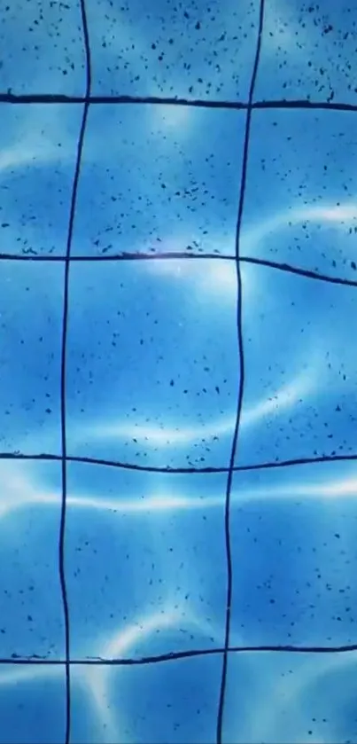 Blue pool tiles with water reflection creating a serene aesthetic.